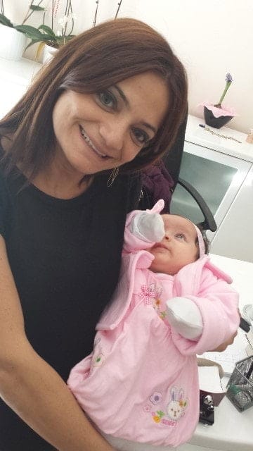 Dr. Mürüde Çakartaş Dağdelen with a baby in her arms
